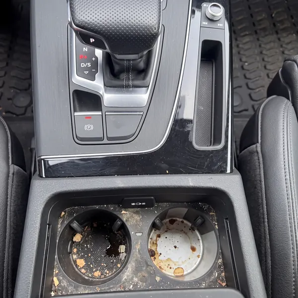 Before: Audi Q5 cup holders and console, coffee stains and crumbs before, clean after